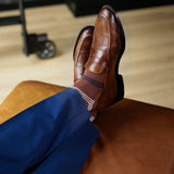 A pecan brown men's dress sock with navy and white stripes