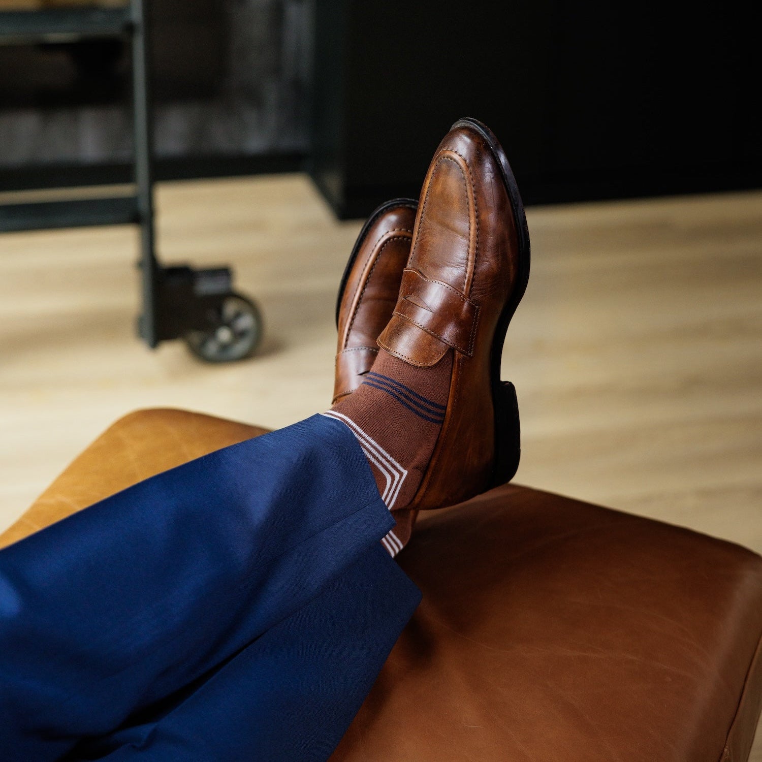 A pecan brown men's dress sock with navy and white stripes