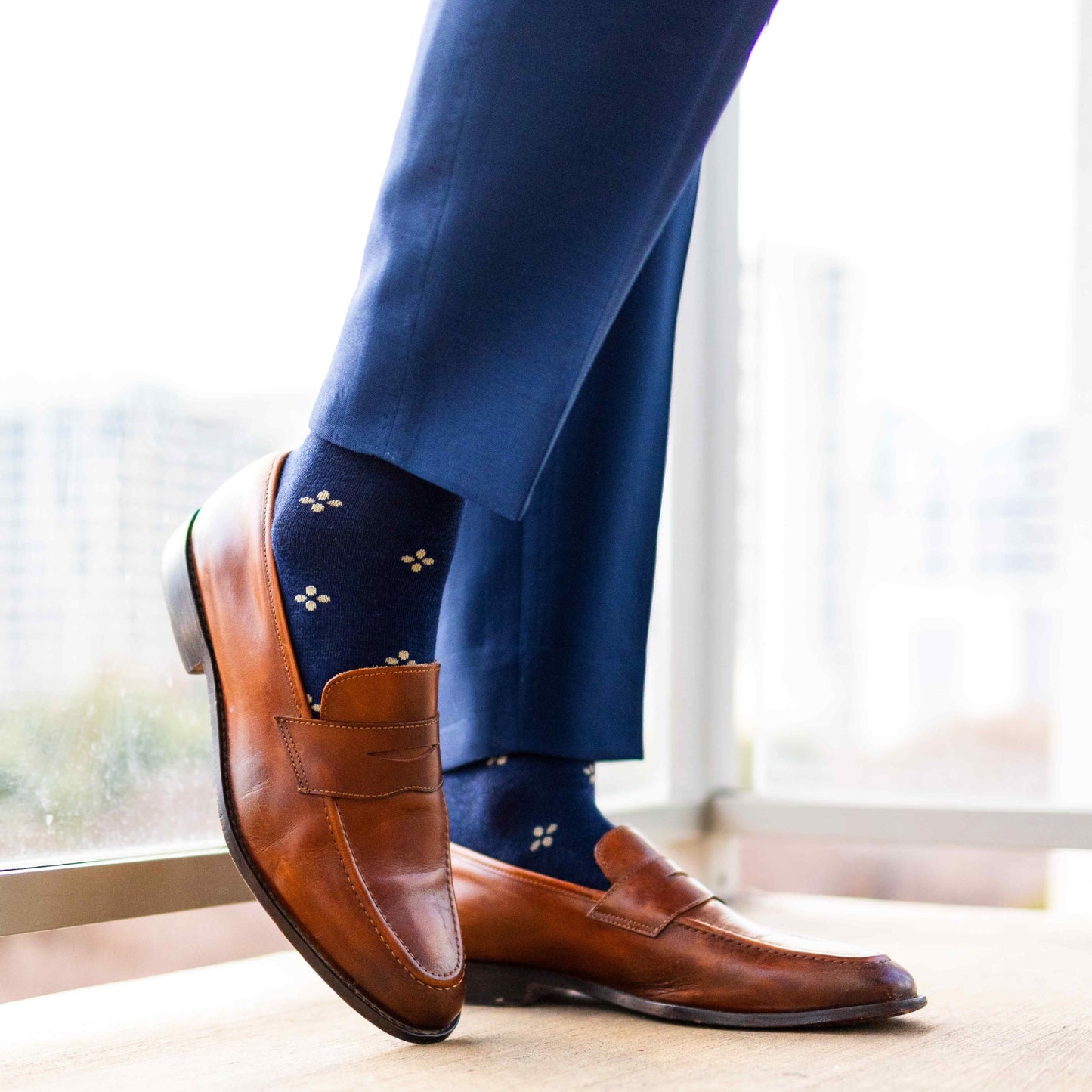 Navy men's dress socks with a gold flower pattern