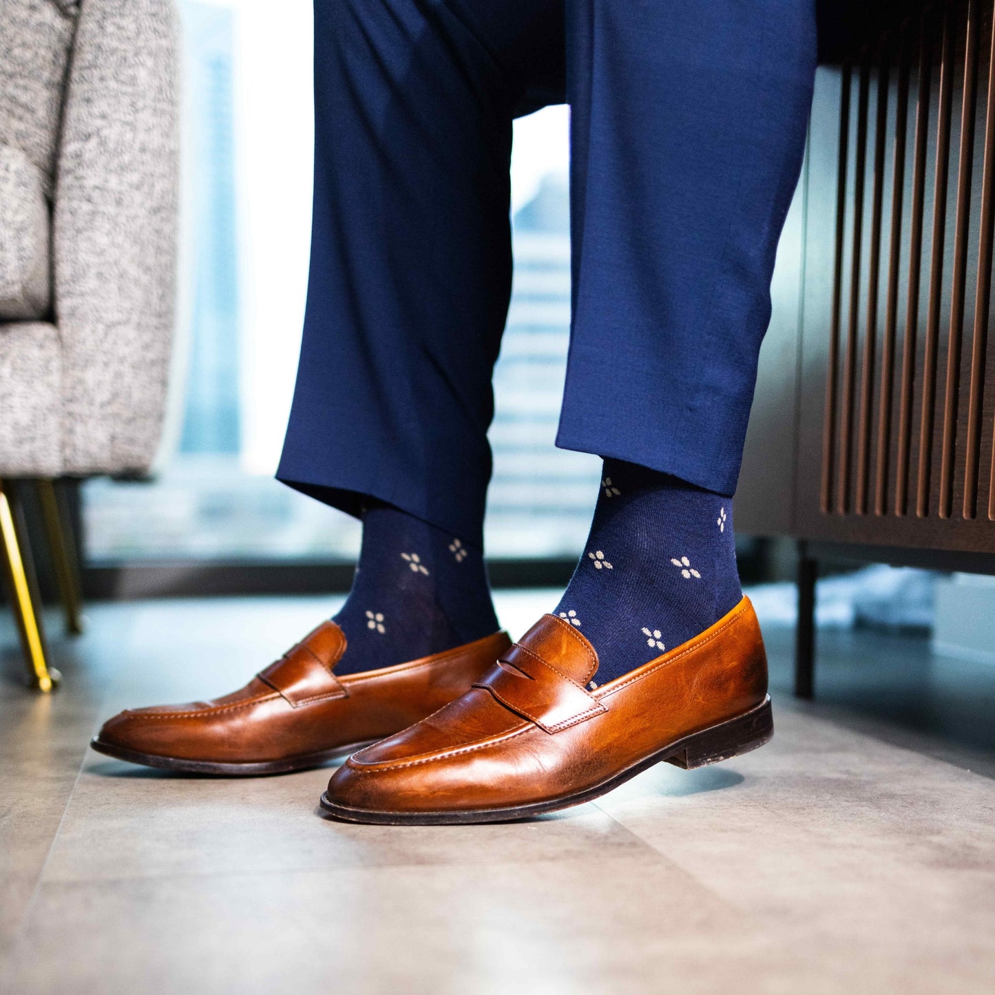 Navy men's dress socks with a gold flower pattern