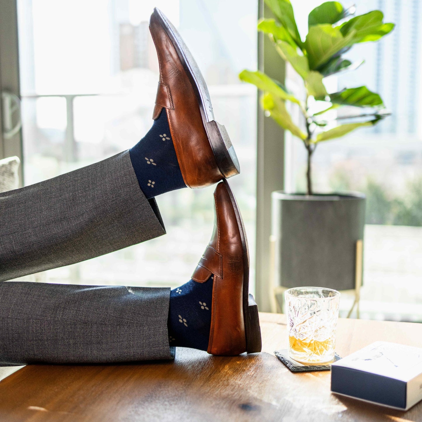 Navy men's dress socks with a gold flower pattern