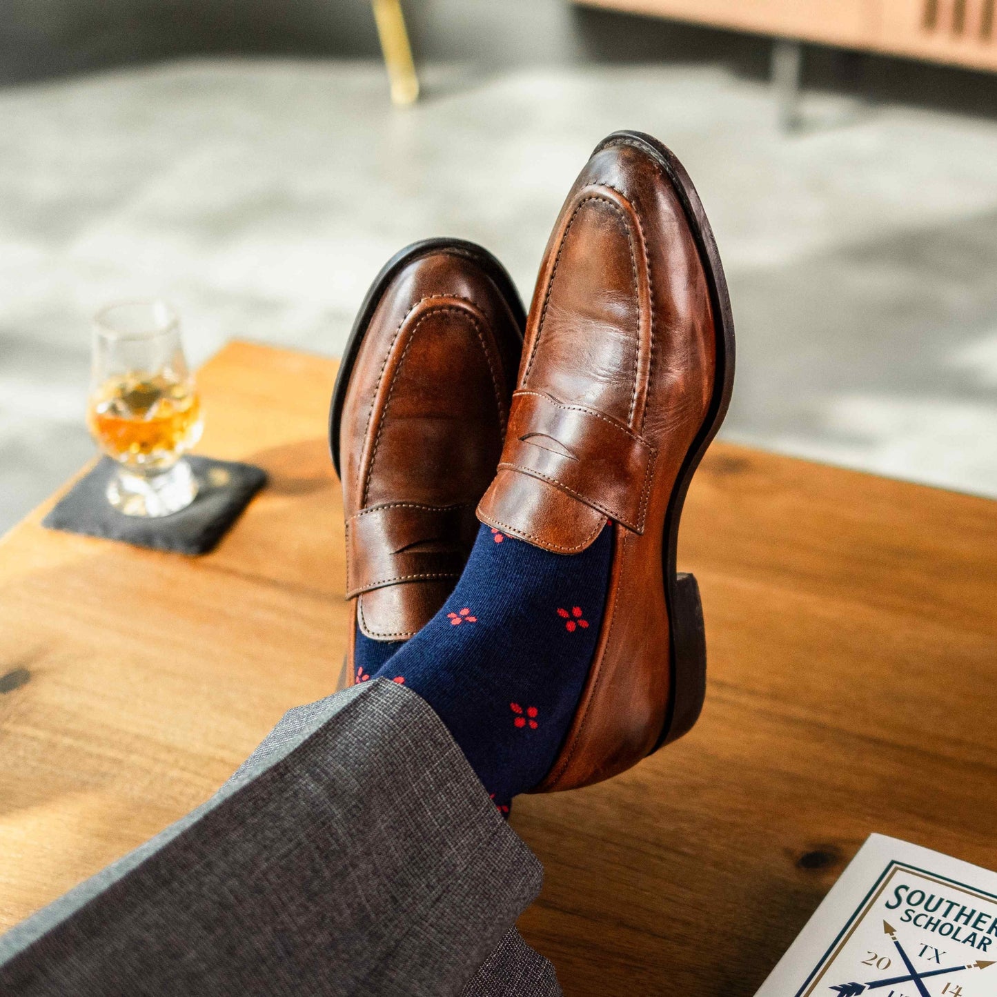 Navy blue men's sock with a cherry red flower pattern