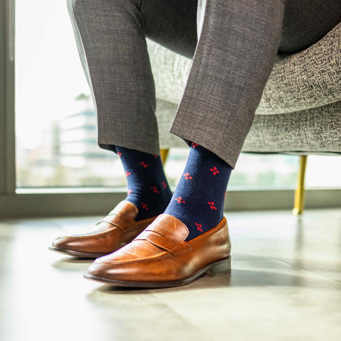 Navy blue men's sock with a cherry red flower pattern