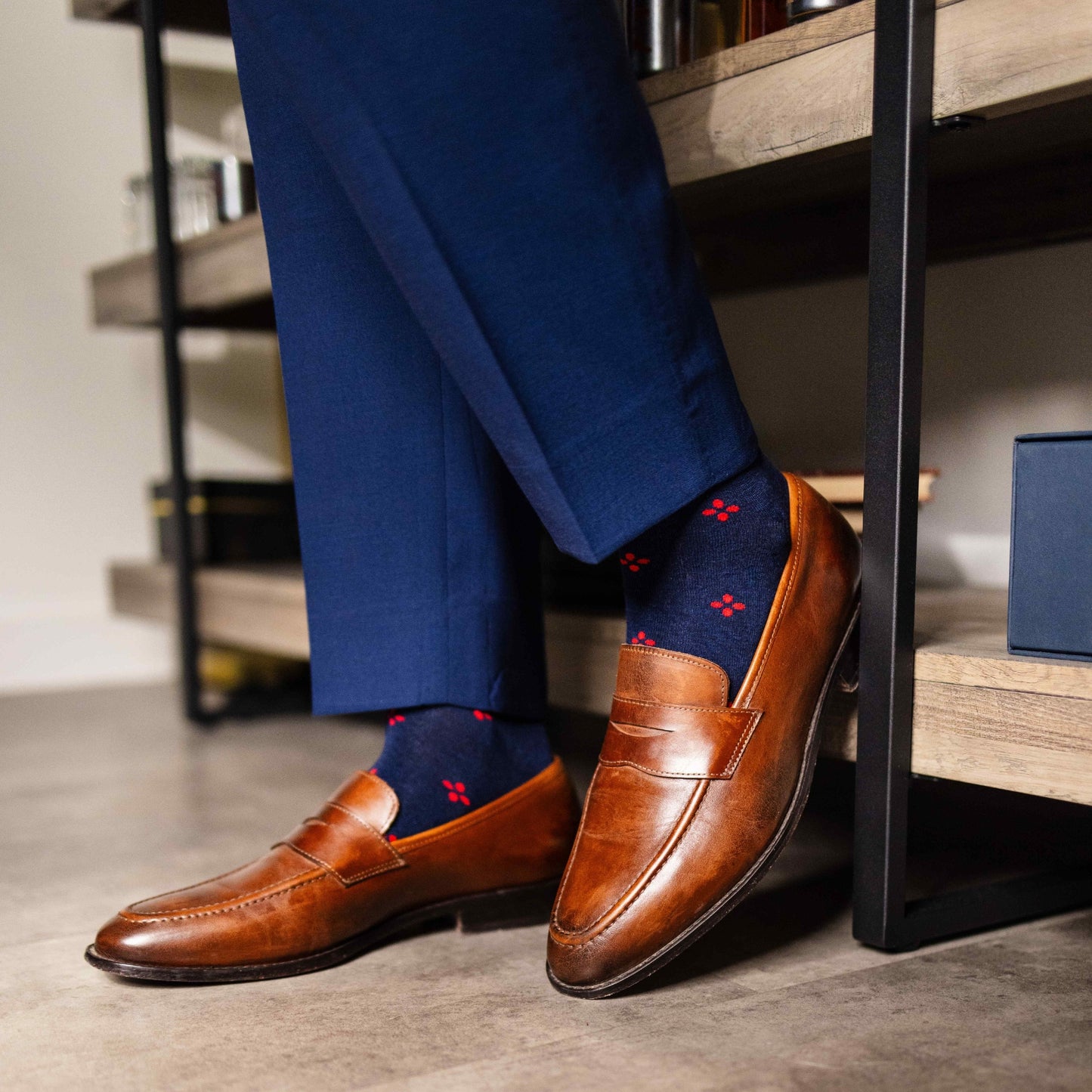 Navy blue men's sock with a cherry red flower pattern