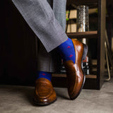 guy in grey slacks wearing royal blue men's dress socks with a red floral flower pattern