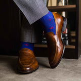guy in grey slacks wearing royal blue men's dress socks with a red floral flower pattern