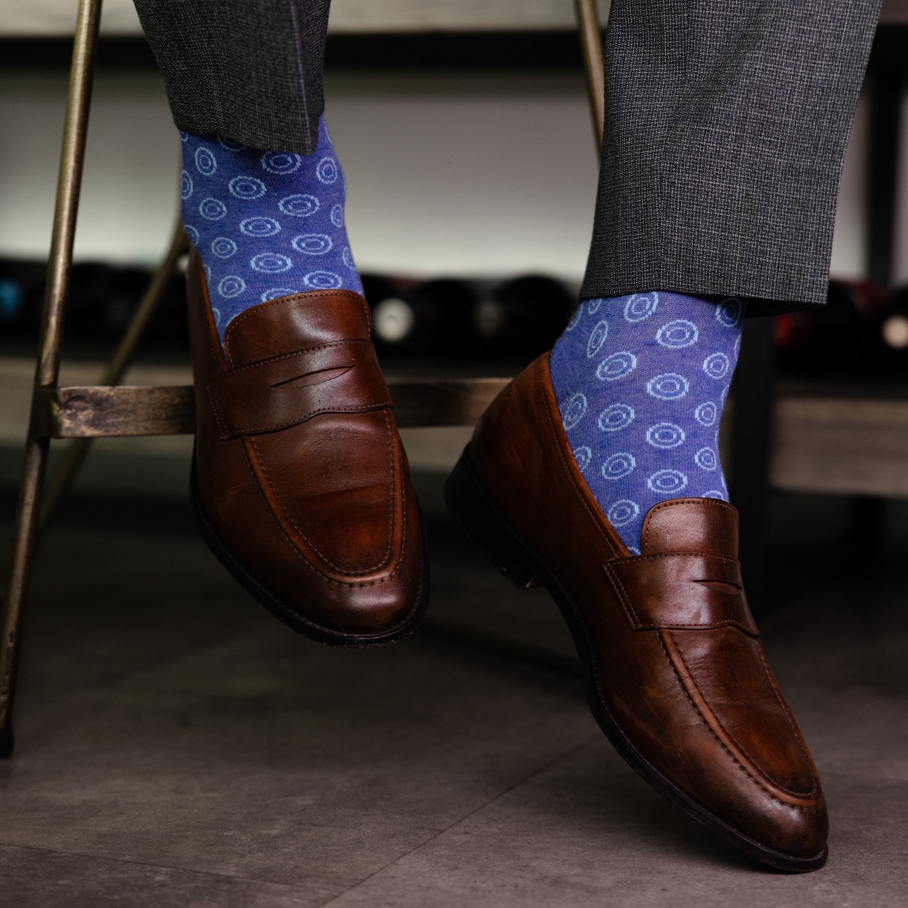 A heathered blue sock with light blue double dots