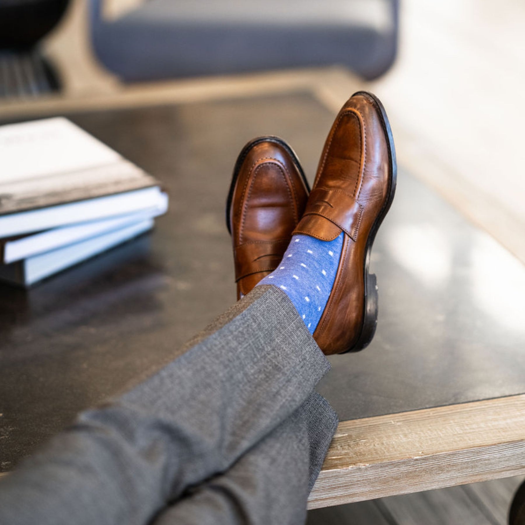 Man wearing heathered blue men's dress sock with ocean blue micro squares with grey slacks and brown shoes