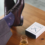 A Prussian Blue men's dress sock with a blush pink flower pattern