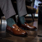 Man wearing hunter green, solid, Emerald ribbed men's dress socks with brown shoes.