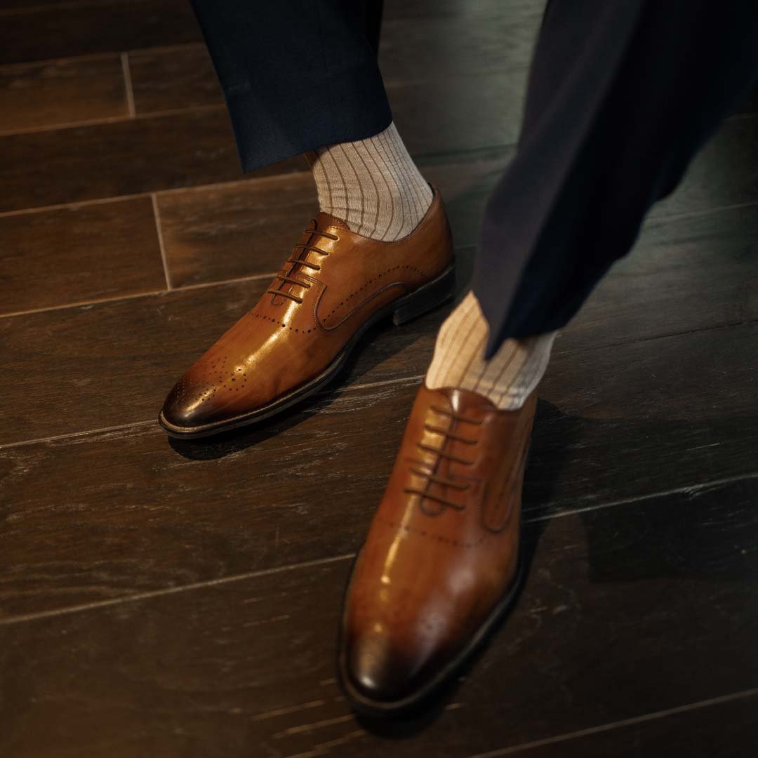 Man wearing oatmeal, solid, mocha ribbed men's dress socks.