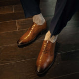 Man wearing oatmeal, solid, mocha ribbed men's dress socks.