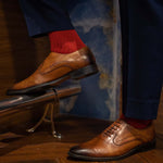 Man wearing rose red ribbed men's dress socks.