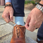 Man wearing blue socks and jeans