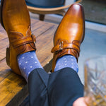 Man sitting wearing heathered blue and ocean blue micro-square socks