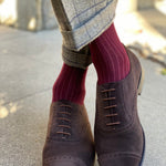 Man wearing solid, merlot ribbed men's socks with dress shoes.