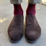 Man wearing solid, merlot ribbed men's socks with dress shoes.