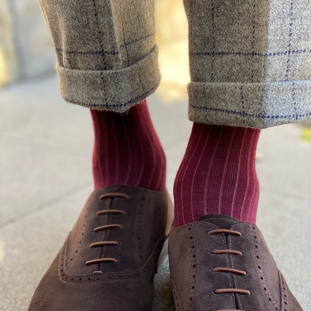 Man wearing solid, merlot ribbed men's socks with dress shoes.