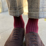 Man wearing solid, merlot ribbed men's socks with dress shoes.