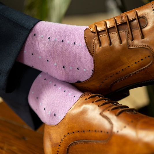 Guy wearing a periwinkle men's dress sock with navy and baby blue pin dots pattern