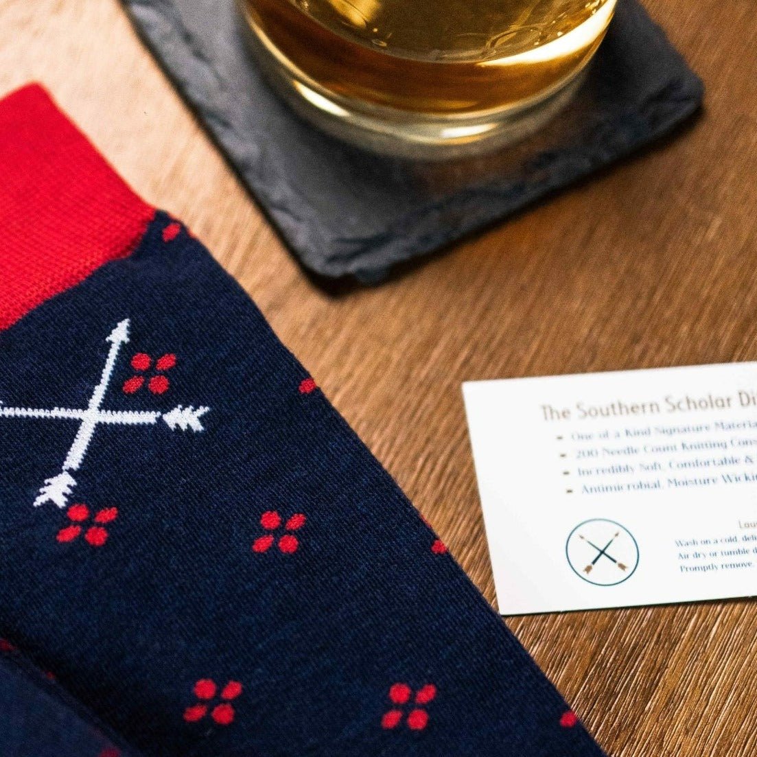 Navy blue men's sock with a cherry red flower pattern
