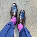 Man wearing fuchsia, solid, ribbed men's dress socks with brown shoes.