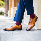 Man wearing Deep red sock with light blue pin dots
