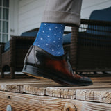 Man standing wearing heathered blue and ocean blue micro-square socks