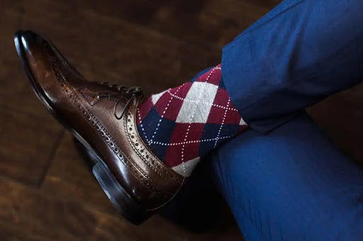 Argyle dress socks with brown leather shoe and navy trousers