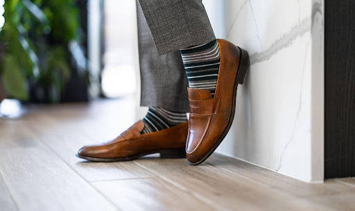 Brown leather loafers with grey striped dress socks.