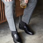 The Black & Silver Square-Grid styled with medium grey trousers with black penny loafers