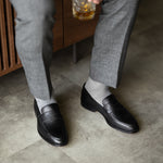 The Pearl Grey Square-Grid styled with medium grey trousers with black penny loafers