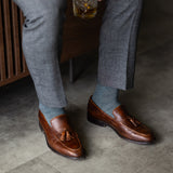 The Sage Green & Taupe Square-Grid styled with medium grey trousers with brown tassel loafers