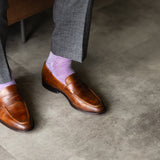 The Lavender & Plum Square-Grid dress sock with a loafer in a raised-foot close-up