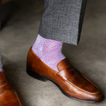 The Lavender & Plum Square-Grid dress sock with a loafer in a raised-foot close-up