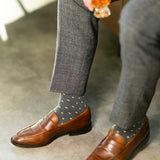 Close-up of dark grey Gemstones dress socks with grey trousers and brown leather loafers
