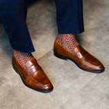 Pecan patterned dress socks with navy trousers and brown leather loafers