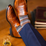 Mocha multi-stripe dress sock with navy trousers and brown penny loafers