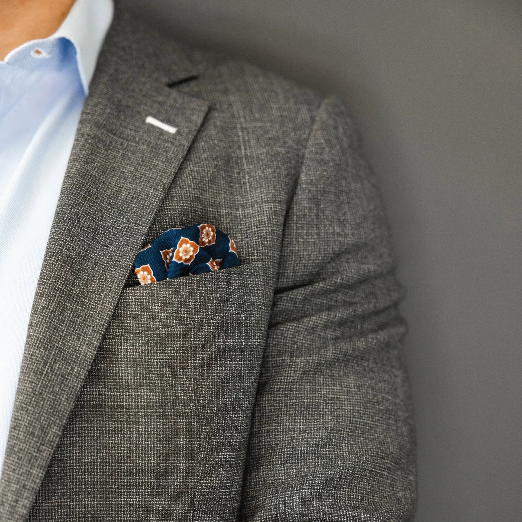 blue and brown floral patterned italian silk pocket square with grey suit and blue shirt