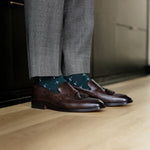 deep green men's dress sock with a white t-sun pattern