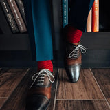 a deep red men's dress sock with a contrasting diamond pattern