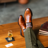 Mocha Multi-Stripe men's dress sock — mocha sock with espresso, teal, and pale blue stripes styled with olive trousers