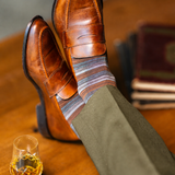 Mocha Multi-Stripe men's dress sock — mocha sock with espresso, teal, and pale blue stripes styled with olive trousers