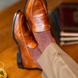 The Pecan & Navy Lattice men's dress sock — pecan brown sock with a navy lattice pattern styled with tan trousers