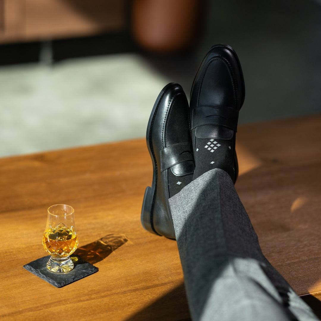 The Black Nested Diamonds men's dress sock — black sock with grey nested diamonds lifestyle image