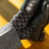 The Black & Silver Lattice men's dress sock — black sock with a silver lattice pattern lifestyle image