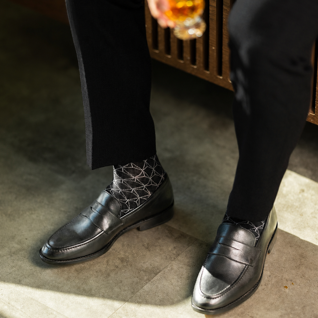 The Black & Silver Lattice men's dress sock — black sock with a silver lattice pattern styled with black trousers