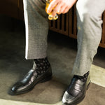 The Black & Silver Triangles men's dress sock — black sock with silver triangle accents lifestyle image