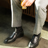 The Black & Silver Triangles men's dress sock — black sock with silver triangle accents lifestyle image