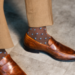 The Mocha Gemstones men's dress sock — mocha sock with navy, white & powder blue gemstones styled with tan trousers